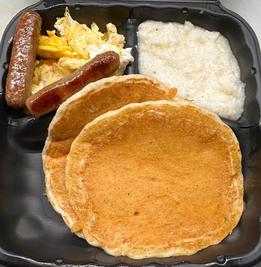 Big Daddy Breakfast with pancakes, plain grits and scrambled hard eggs